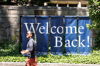 Yale reunion attendee walking past "Welcome Back" sign