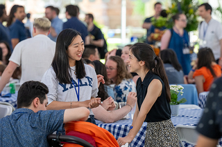Yale alumni interacting with each other at reunion event outside
